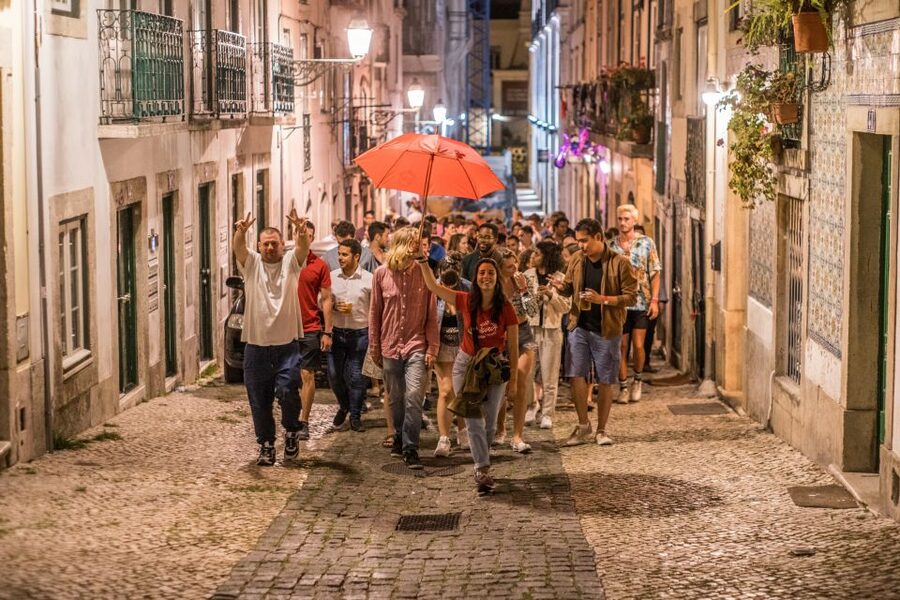 Lisbon: Pub Crawl with Open Bar and VIP Club Entry - Bairro Alto at night: why this crawl starts where it should
