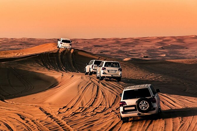 Premium Desert Safari with Dinner, Dunes and Ten Shows (VIP) - Red dunes and the main event: dune bashing, sandboarding, and the camp rhythm