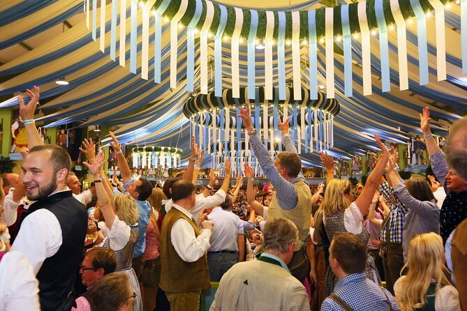 VIP Oktoberfest experience with table in big beer tent - The walk around the grounds: fun rides and stories that change how you see it